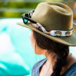 Woman wearing at hat with Croakies eyewear retainers