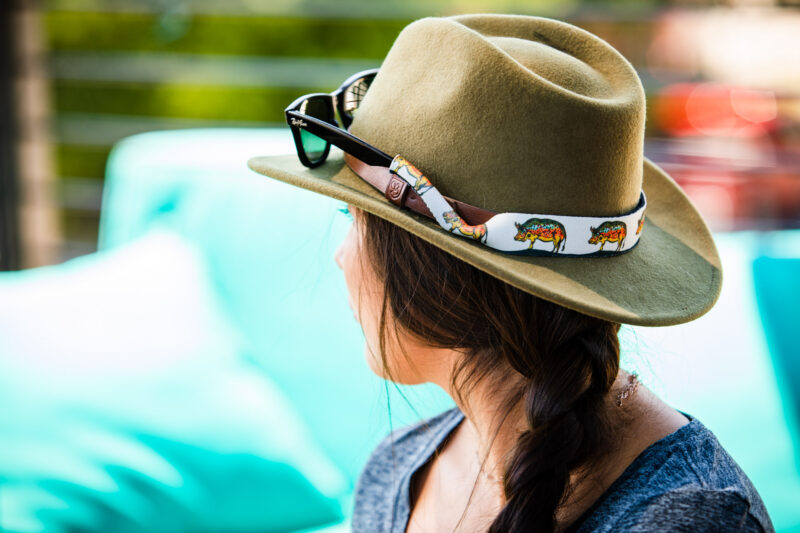 Woman wearing at hat with Croakies eyewear retainers